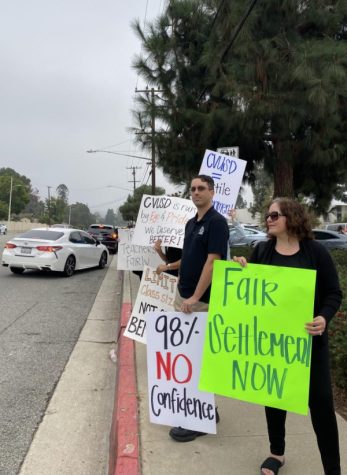 South Hills teachers line up along the front of campus before school wearing all black, holding signs, and encouraging cars to honk for support on Thursday October 6, 2022.
