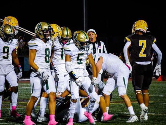 Tyler Lopez #5 flexing and celebrating after making a big tackle in the South Hills win over Don Lugo.