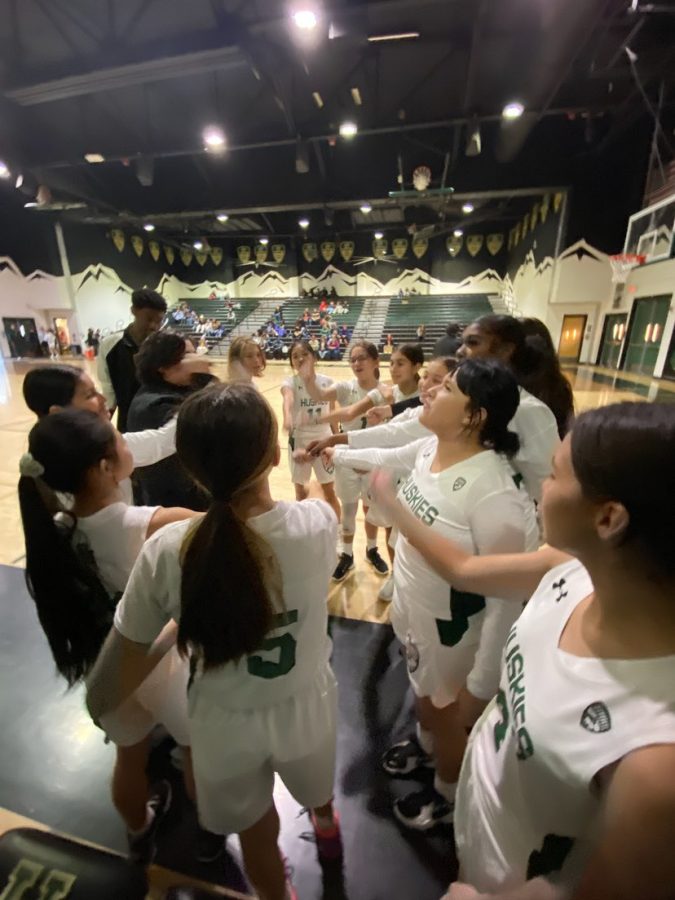 The+girls+frosh+basketball+team+huddle+during+the+game+on+December+14%2C+2022.+