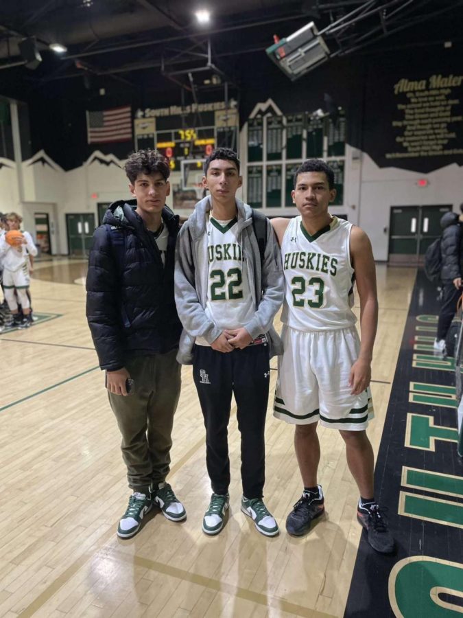 Seniors Matthew Reynoso (left), Daniel Gonzalez (middle), and Tristan Kristoffer Cuasay (right) get ready for practice at the South Hills gymnasium.