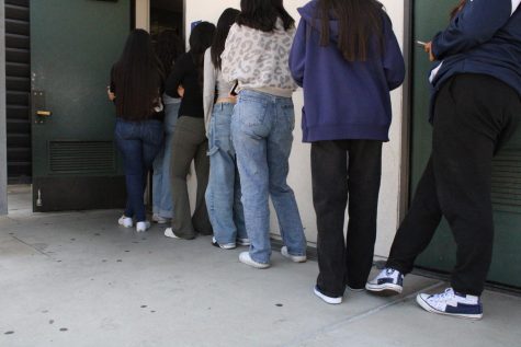 A line forms outside the girls restroom during passing period.