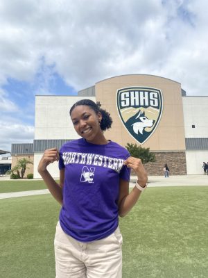 Saniya poses in front of the South Hills High School Gym in Northwestern attire.