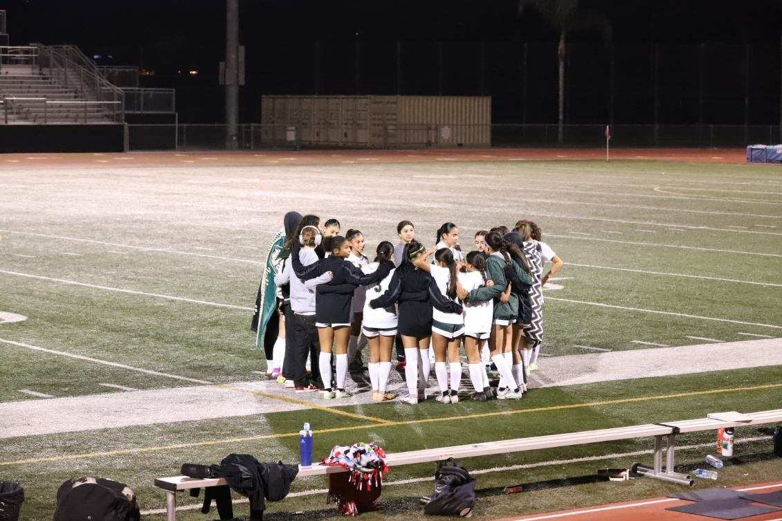 The girls varsity soccer team get together before the second half of the preseason game against La Serna on December 7, 2023