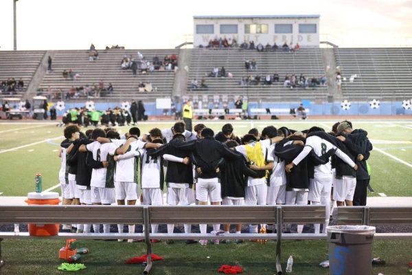 The South Hills boys varsity soccer team prays before their game against Walnut. 