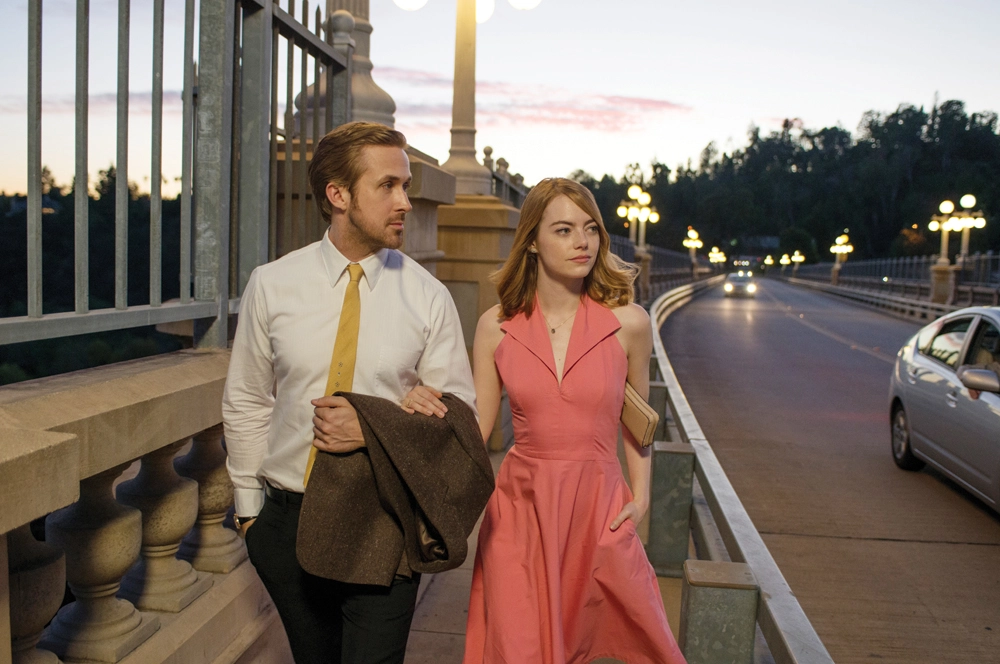 Ryan Gosling as Sebastian Wilder(Left) and Emma Stone as Mia Dolan (Right)  take a walk down the Colorado Street Bridge in Pasadena, CA.