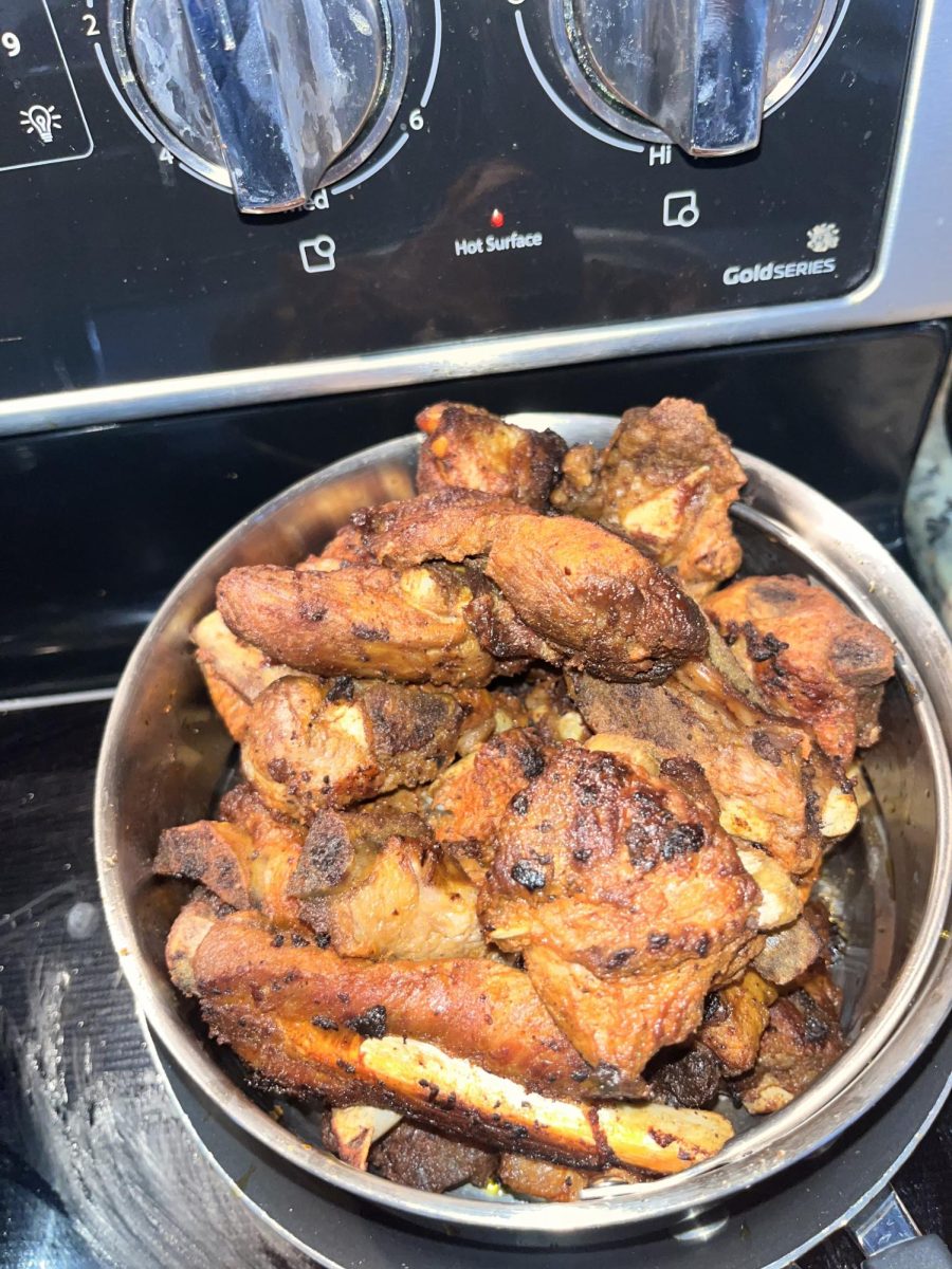 Abraham Locayo's mom prepares grilled pork for the family during their trip to Miami.