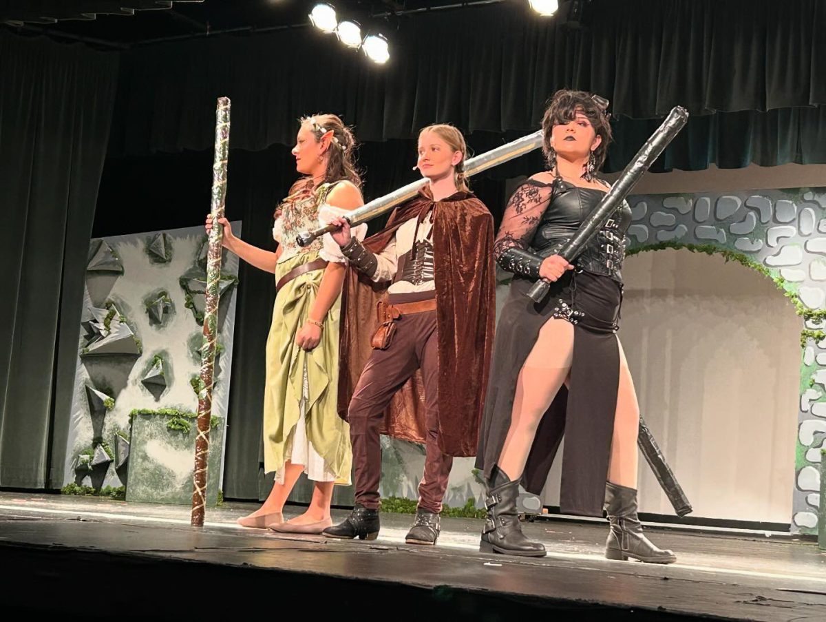 Hailey Westervoorde (11), Willow Eichen (12), and Jules Booth (11) pose after killing monsters during rehearsal.