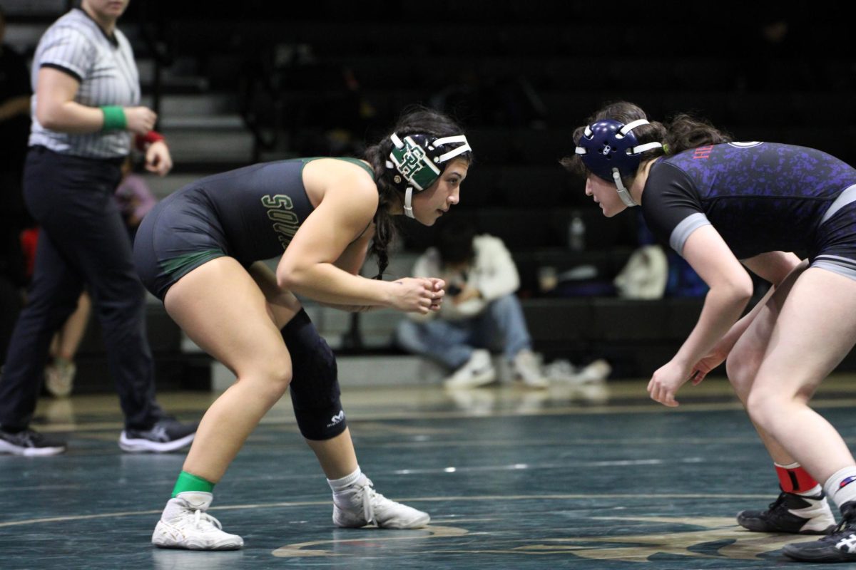 Julianna Perez (12) prepares to take down her opponent during senior night on January 21.