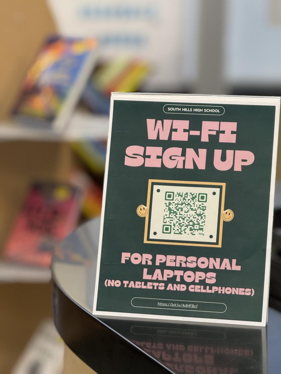 A sign in the SHHS library, provides students with a QR code to connect to school Wi-Fi. The network is restricted to school-issued devices and personal laptops for instructional purposes.