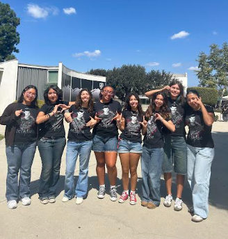 Keena Weigel (12), third on the right,   poses for a photo with her friends while “repping their pack” on Wednesday by wearing shirts with Jacob’s face from Twilight. 