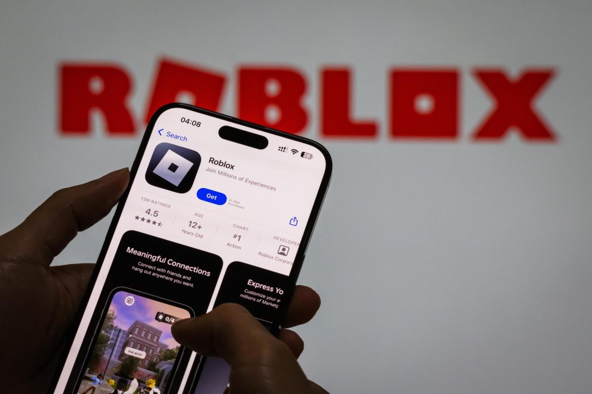 A user downloads Roblox on a mobile device as the company faces mounting allegations.