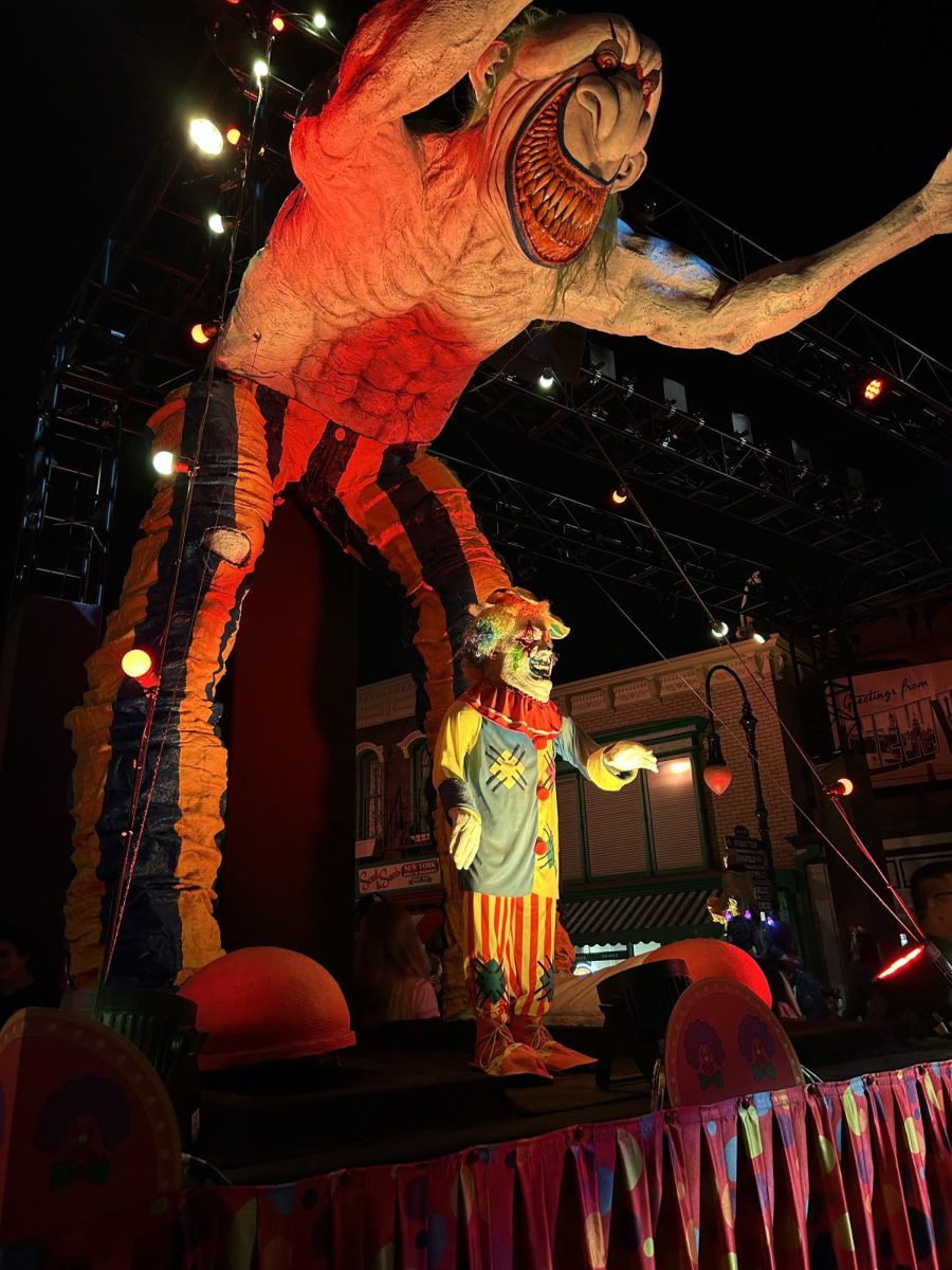 A clown greets guests at the entrance of Universal Studio's Halloween Horror Nights. 