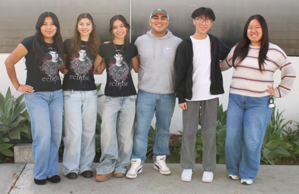 Tania Osuna-Rocha (12), Eliana Villatoro (12), Keena Weigel (12), Christopher Morales (12), Ethan Bui (11), and Mandy Guan (11), left to right, pose for a photo on Dec. 12, after preparing scrambled eggs, bacon, and pancakes for the yearbook staff's end of semester potluck.