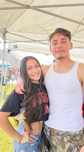 Karlett Morales (12) and her brother Kristian pose for a picture at a USC tailgate on November 29. 