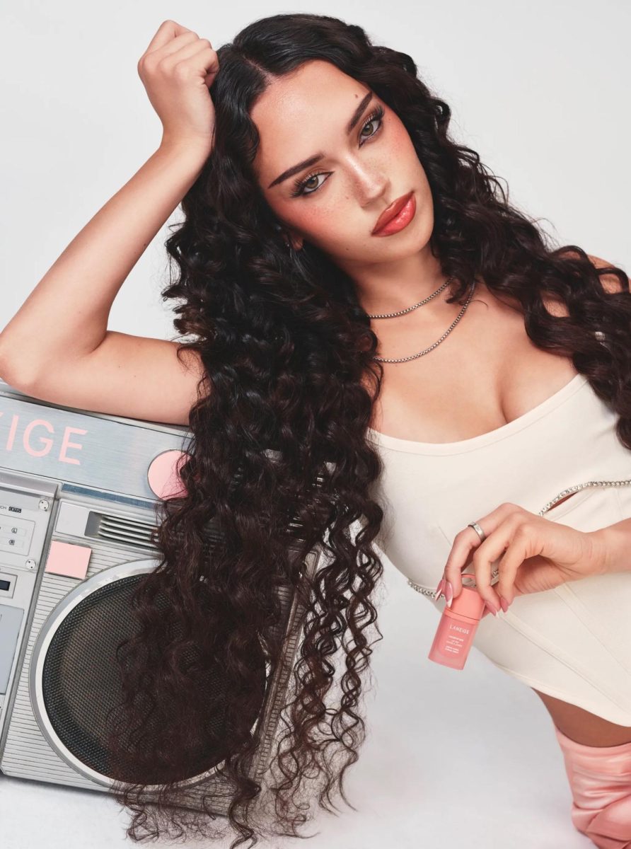 KATSEYE's Daniela hold's her chosen shade, Disco Coral, in which the name reflects off of her love for dance, especially as the girl group's main dancer.