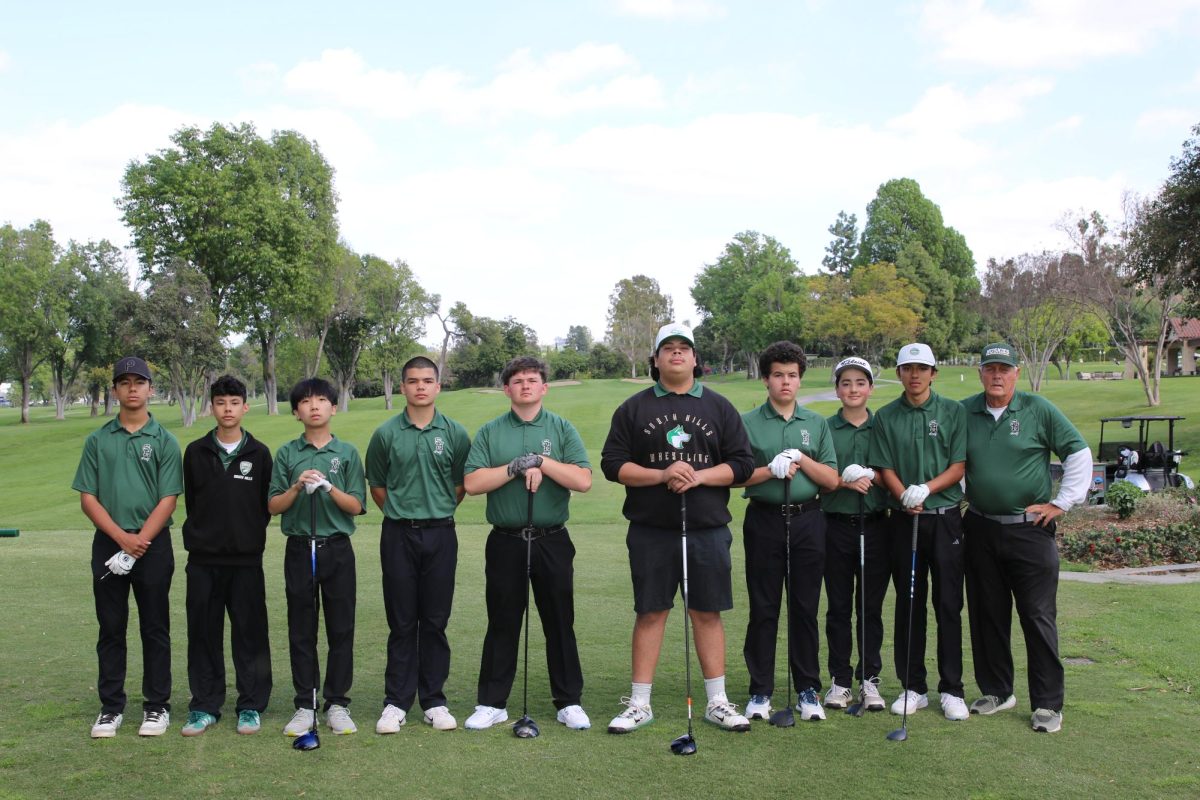 The South Hills golf team poses with their coach after a match.