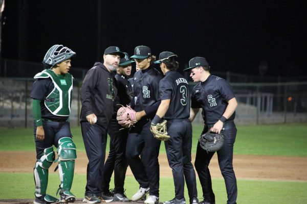 Coach Murphy huddles with his team on March 3 during a home game. 