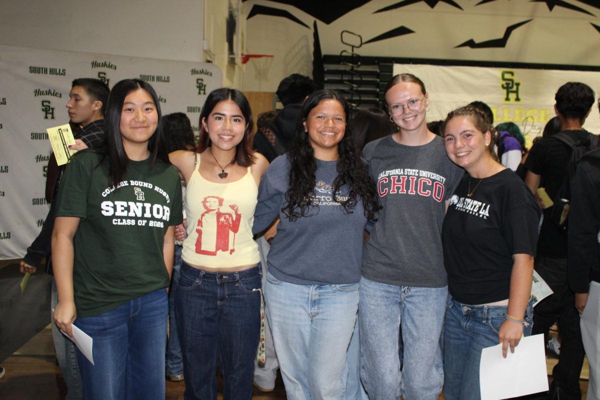 [left to right] Arissa Lam (12), Sarah Powert (12), Magdalena Kenyon (12), Sophia Frogue (12), and Stevie Feld (12) pose with their college decision shirts on May 1. 